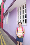 Little Cat in front of a Purple House
