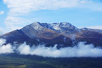 
High above the clouds - the snow mountain guarding Kanas Lake
