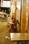 Someone using dinner in the Temple St.