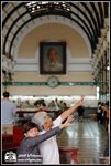 At the Post Office, photo of Mr Ho Chi Minh behind. But what are they doing...