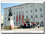 Mozartplatz, with a group of students singing a part of his opera in front of his statue. Amazing~