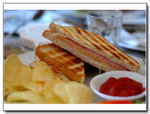 Cheese and ham sandwich with chips
