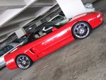 This picture makes it like a red car posting in front of a B&W background.  Infact, the picture was taken in full color mode.