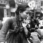 
027A...This is a superb image; Hedda Morrison has waited for 
a "decisive moment", reflecting the woman��s pensive mood.