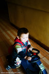 this kid was funny.  he was riding his toy cart around without any facial expression at all.