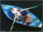 Lubian earn their living by throwing goods from their row boat to the cruising tourist