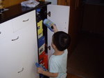 Hei Hei put shoe into cabinet