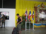 solider, tourist and the king outside Chiang Mai Airport