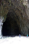 The height of a person compared to the size of the cave opening