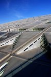 The partly-glazed roof which tilts towards the sea is designed to angle sunlight to the inside of the library.