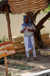 Papyrus making. He is not cutting the sugar cane for chewing.