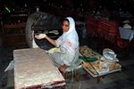 Egyptian woman making bread in Byblos. Besides her is the oven. It is not usual to see Egyptian women working in public.