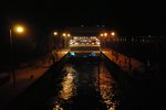 One by one, the ships have to queue up to cross this lock (a narrow passageway opened up from a bridge for ships to cross)