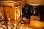 Tomb of Tutankhamen - The Treasury: This room contained some of the richest pieces in the tomb. The cube is the gilded canopic shrine decorated with scared cobras and sun-disks, with round the sides the four goddesses, Isis, Nephthys, Neith and Selket, who are stretching out their arms to protect the royal viscera (ie the four organs of the King)