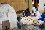 A woman is making bread.. doesn't look like a demonstration to me..