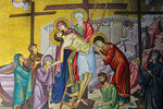 A mosaic depiction of Christ's body being taken down from the cross after he has died.