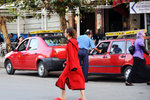 The color of the taxis in Fes is red, ie same as the woman's dress...