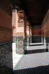 The pillars are decorated with zellij tilework below and carved plaster above.