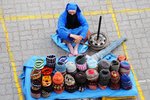 Another old woman selling hand-knitted caps