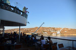 People gathering at the back of the ship to watch the ship set sail away from Mykonos