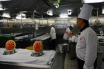 The Chef (who has a black necktie) was showing us around the galley