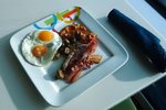 Typical breakfast with bacon, mushroom, baked beans and sunny side up