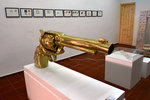 A gigantic golden gun displayed inside an art gallery inside the old city